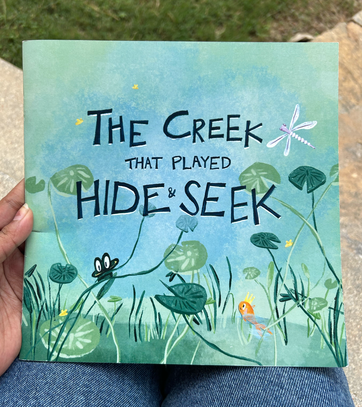 The Creek That Played Hide and Seek — book cover, propped on a chair