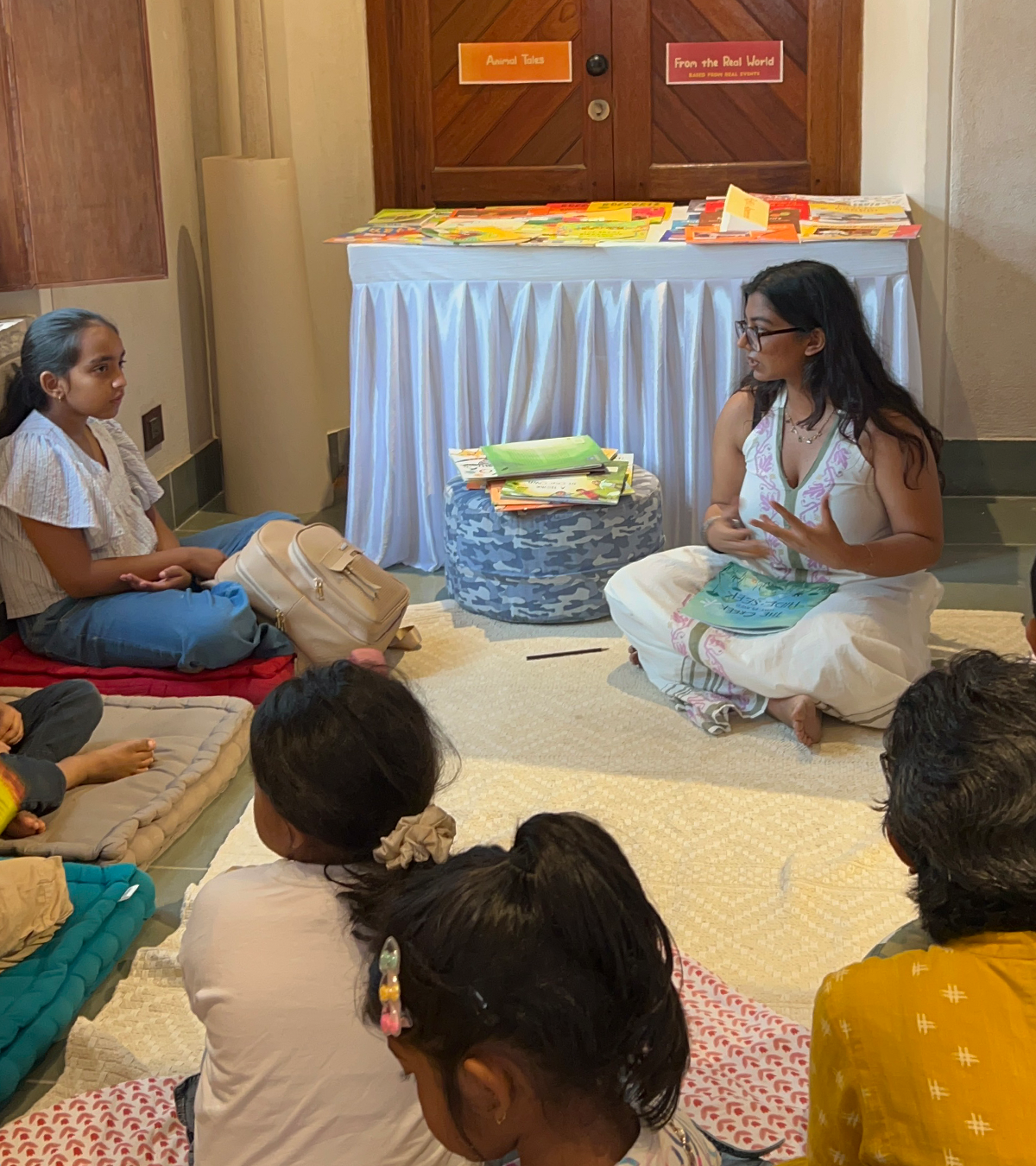Live storytelling session — reading the book aloud to a circle of children