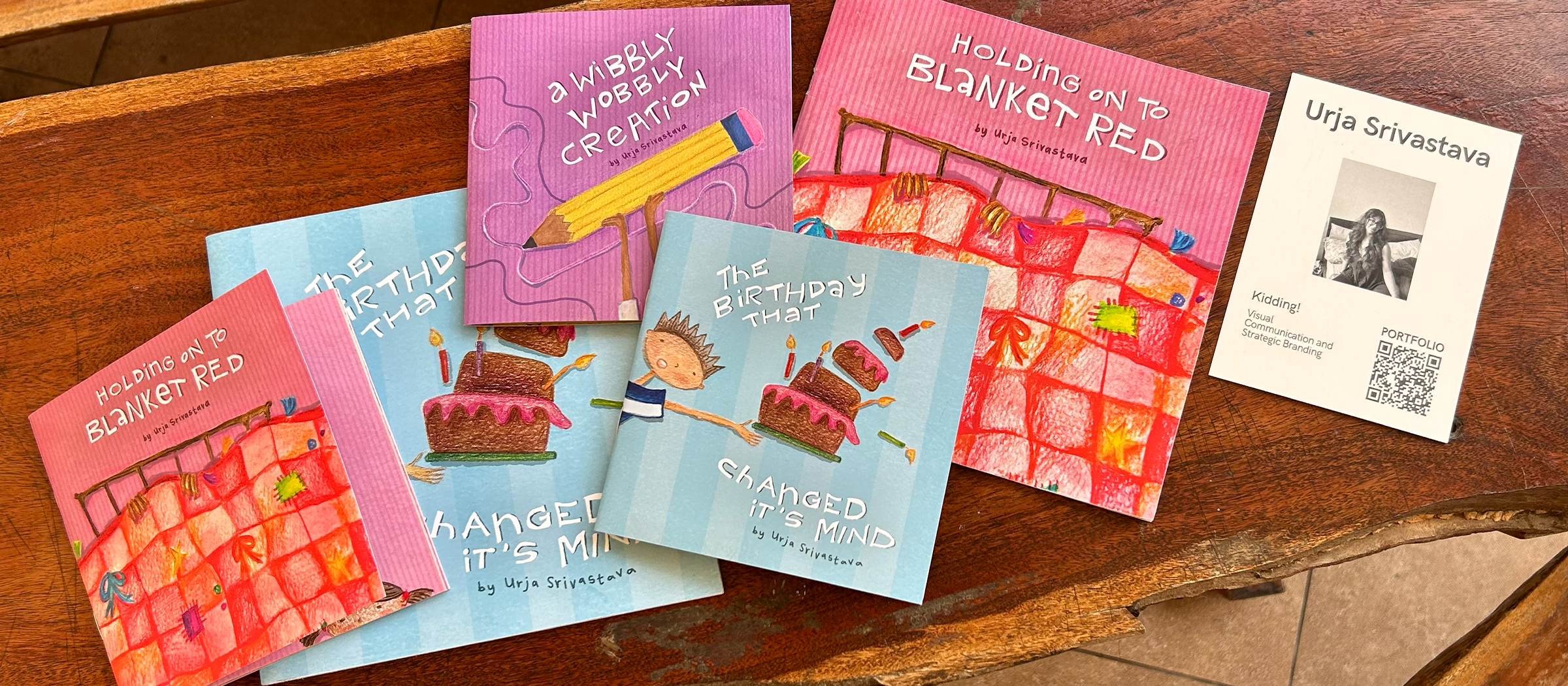 Heart to Heart — all three books fanned out on a wooden table with a business card